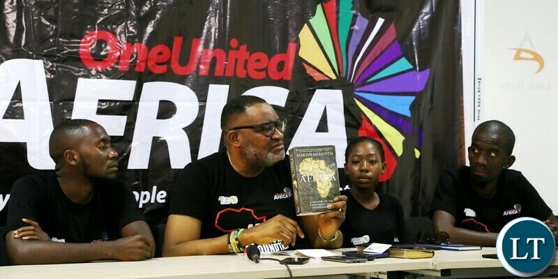 Initiator, One united Africa Congressman Bimbo Daramola flanked by his team showing book written on Africa during the media briefing in preparation of celebrating African Union Youth Day which falls in 1st November, at Asmara hotel in Lusaka