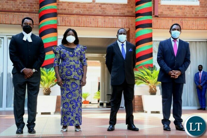 President Hakainde Hichilema and Vice President Mutale Nalumango pose for the picture with the newly appointed Attorney General Mulilo Kabesha (2nr) and newly appointed Solicitor General Marshal Muchende (l) shortly after swearing in ceremony at State House