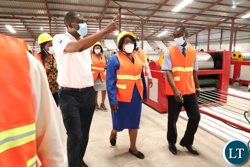 Labour Minister Brenda Tambatamba flanked by Marcopolo Tiles Company  Limited Acting Chief Executive officer Roy Chisanga Mwamba (in white shirt)  during a tour of Marcopolo Tiles Limited on Thursday, October 14,2021-Pictures by THOMAS NSAMA   