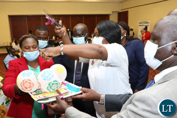 Minister of Labour Brenda Tambatamba cutts a ribbon as ZCTU president Chishimba Nkole (R) during the official Launch of the World Day for Decent Work at Pamodzi Hotel in Lusaka on Wednesday, October 6,2021- Picture by THOMAS NSAMA/ ZANIS