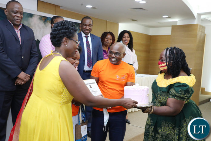Zambia Tourism Agency Board Chairperson Dr Tecla Ngwenya receives a gift from ThornHill primary School Director Mary Chungu (R) during the Tourism Writing and Arts competition prize giving ceremony for Primary schools at Government complex in Lusaka on Moday, October 11,2021 -Picture by THOMAS NSAMA/ZANIS
