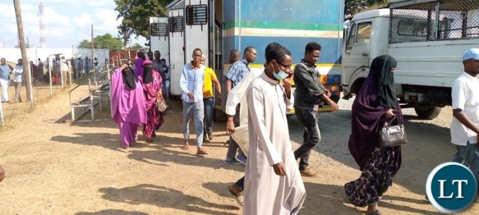 Suspected illegal immigrants arriving at Ndola's Musakasonka Stadium where they were taken for screening after a joint clean-up operation that was undertaken by the department of immigration and other security wings on October 29,2021. 128 illegal immigrants were apprehended and are currently detained at Kansenshi correctional facility in Ndola. Suspected illegal immigrants arriving at Ndola's Musakasonka Stadium where they were taken for screening after a joint clean-up operation that was undertaken by the department of immigration and other security wings on October 29,2021. 128 illegal immigrants were apprehended and are currently detained at Kansenshi correctional facility in Ndola.