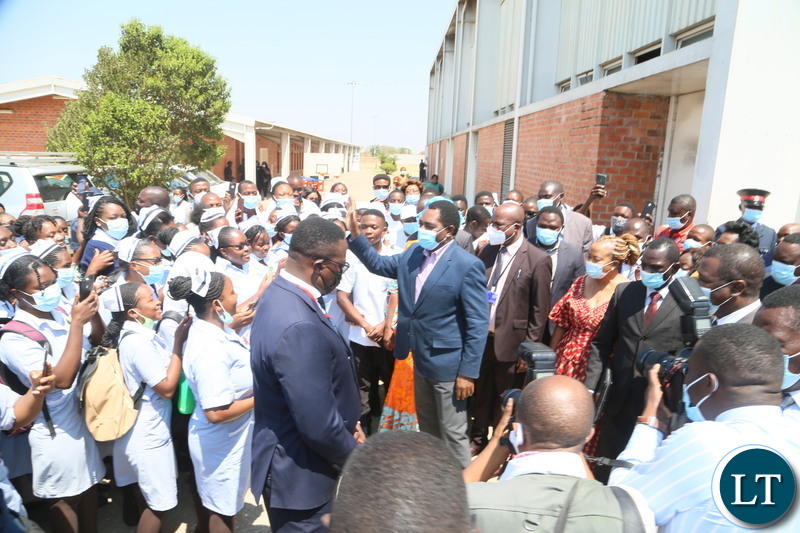 President Hakainde Hichilema confers with nurses when he toured the stands during the relaunch of COVID-19 vaccine at OYDC