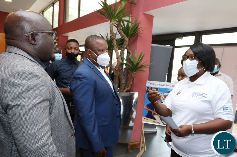 Minister of Labour Brenda Tambatamba (R) talks to FFTUZ Secretary General Victor Muyumba (L) as FFTUZ president Chingati Msiska (C) looks on during the official Launch of the World Day for Decent Work at Pamodzi Hotel in Lusaka on Wednesday, October 6,2021- Picture by THOMAS NSAMA/ ZANIS