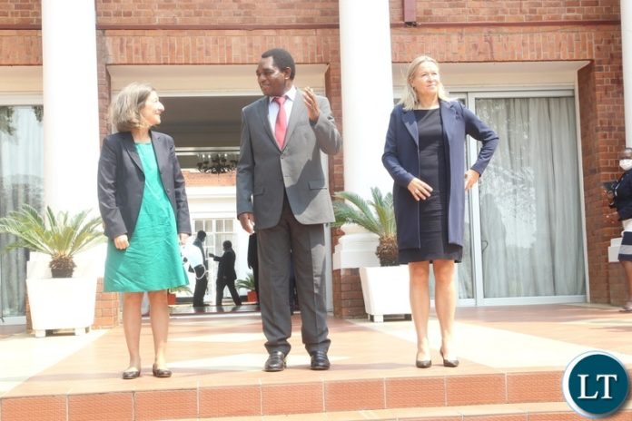President Hikainde Hichilema confers with Director Africa European Commision Sandra Kramer when they paid a courtesy call on President Hakainde Hichilema at state House.Looking on is EEAS Managing Director of Africa Rita Maria Figueiras Laranjinha.