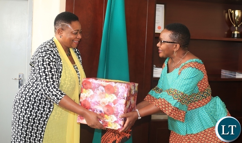 MINISTER of Labour and Social Security,Brenda Tambatamba(right)receives a parcel from Zimbabwean High Commissioner to Zambia,Charity Charamba when she paid a courtesy call on her in Lusaka .