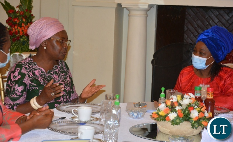 THE First Lady Mutinta Hichilema(r) confers with Mate Musokotwane when the Minister's spouses met her at State House in Lusaka.