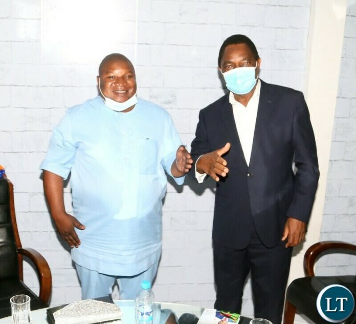 President Hakainde Hichilema shake hands with Kaystech Energy Chief Executive Jonathan Kondowe after bidding the K2.5 million for Coat of during the Gala Dinner and meet the President at Mulungushi Conferance Center