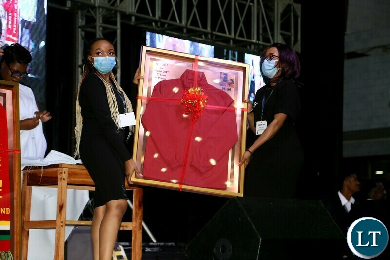 Ushers displays the coat for bidding during the Gala Dinner and meet the President at Mulungushi Conferance Center