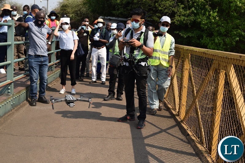 SRDP Consultancy Drone expert Xervy Veloso(right) demonstrating to engineers from Zambia and Zimbabwe on how to conduct special bridge inspections using  drone technology on the Victoria Falls Bridge in Livingstone as Road Development Agency(RDA) senior corporate affairs manager Anthony Mulowa(in white shirt) looks on. The US $ 6.5 million bridge maintenance project is aimed at building capacity in bridge engineers. Picture by KELVIN MUDENDA