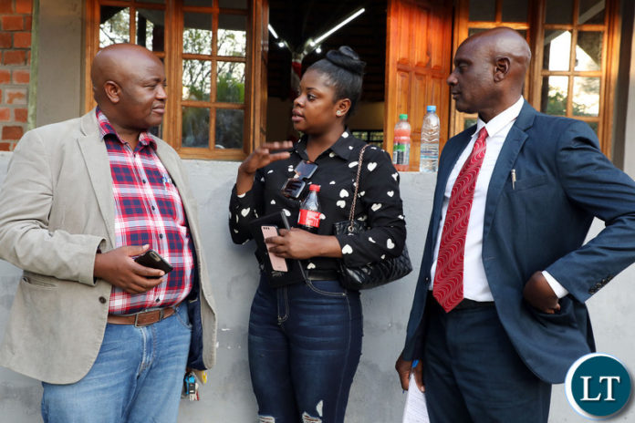 Katuba member of Parliament Mwabashike Nkulukusa (L) speaks with Chibombo District Council chairperson Newton Nyeleti (R) and Zhongkai Ethanol Cassava processing Plant representative Mary Makunka shortly after the Private Stakeholders meeting in Katuba Constituency on Saturday, October 30,2021-Picture by THOMAS NSAMA