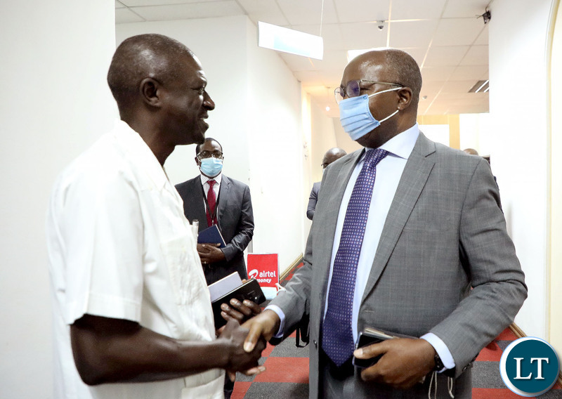 Finance Minister Situmbeko Musokotwane speaks with Noel Nkoma shortly after the Post Budget  Townhall Symposium at Mulungushi International Conference Centre in Lusaka on Monday, November 1,2021 -Picture by THOMAS NSAMA/ZANIS  