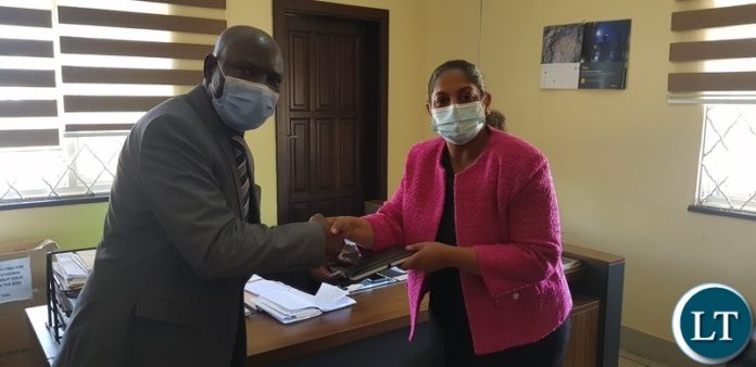 KCM PL Celine Nair greets with Chingola District Commissioner Raphael Chimupi at his office in Chingola