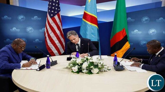 Blinken-DRC-Zambia Signing US Secretary Antony Blinken (C), Democratic Republic of the Congo Foreign Minister Christophe Lutundula (L) and Zambian Foreign Minister Stanley Kakubo sign a memorandum of understanding on the sidelines of the US-Africa Leaders Summit in Washington, DC, on December 13, 2022. EVELYN HOCKSTEIN / POOL / AFP