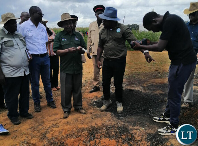 Cotton Board of Zambia executive director Sunduzwayo Banda (in hat) explains the biochar technology to Seed Certification Institute director Francisco Miti during the field day at the Cotton Development Trust in Mazabuka District last Thursday. Picture: Benedict Tembo