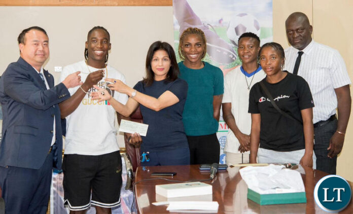 Higer Buses chief executive officer Wu Ming (left), Copper Queens captain Barbara Banda and Jewel of Africa chief executive officer Rashmi Sharma during the unveiling of their donation to the Copper Queens at the FAZ Secretariat .jpeg